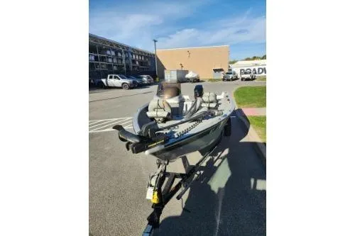 The Image of 2008 Tracker Pro Guide V-16 SC boat on trailer in parking lot. - 1