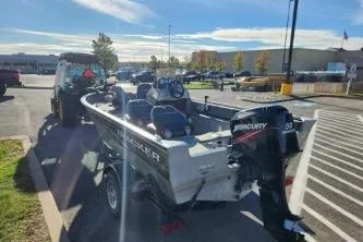 Slide: The Image of 2008 Tracker Pro Guide V-16 SC boat with Mercury engine on trailer in parking lot. - 3
