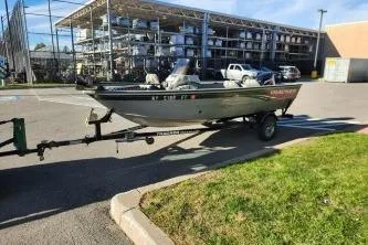 Slide: The Image of 2008 Tracker Pro Guide V-16 SC boat on trailer in parking lot. - 5
