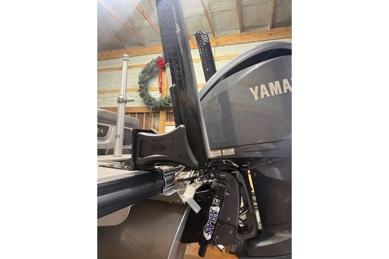 Slide: The Image of 2023 Bennington 23 RSBWA boat with Yamaha engine in a garage setting. - 6