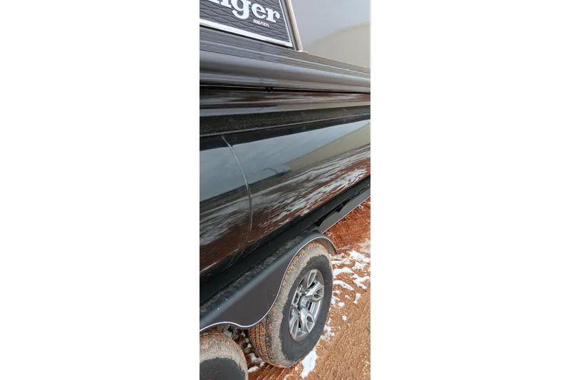 Slide: The Image of 2024 Ranger 2500LS boat trailer on snowy, muddy ground. - 14