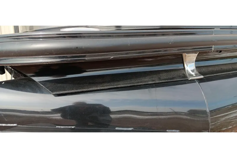 Slide: The Image of Close-up of 2024 Ranger 2500LS boat detail, showcasing sleek black exterior and chrome accents. - 17
