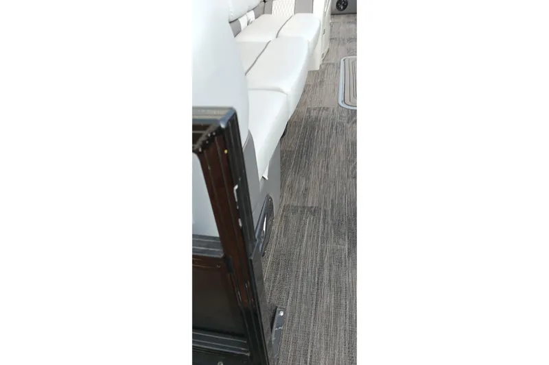 Slide: The Image of Interior of 2024 Ranger 2500LS boat with white seating and gray flooring. - 22