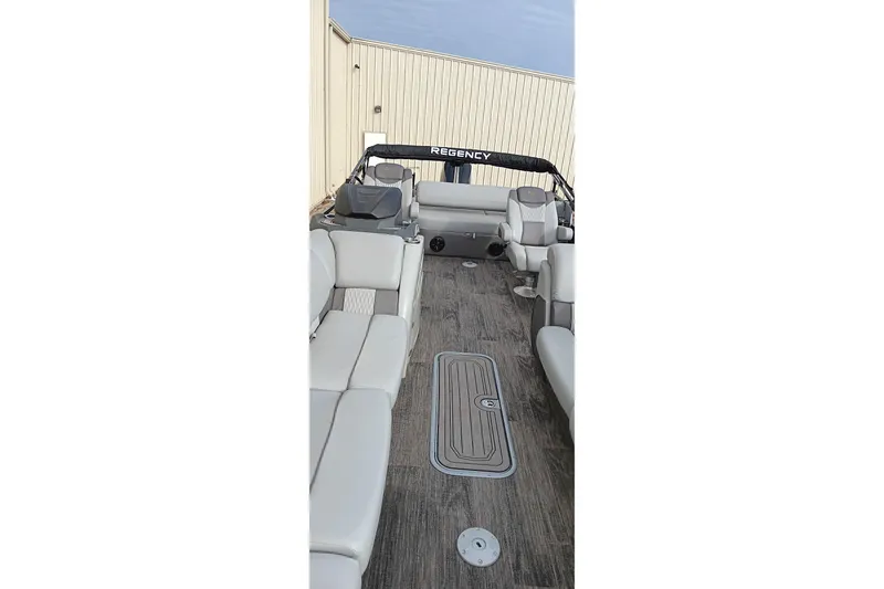 Slide: The Image of 2024 Ranger 2500LS boat interior with gray seating and wood-style flooring. - 23