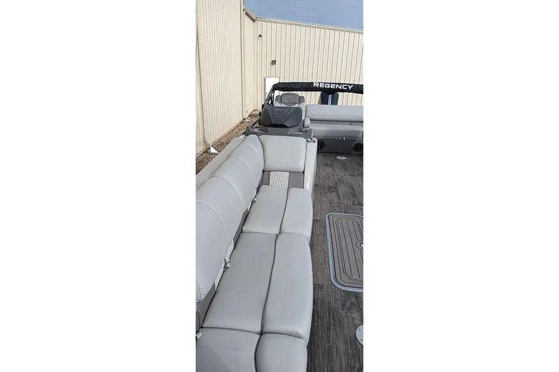 Slide: The Image of 2024 Ranger 2500LS boat interior with gray seating and wood-style flooring. - 24