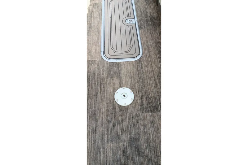 Slide: The Image of 2024 Ranger 2500LS boat deck with wood finish and hatch detail. - 26