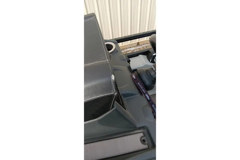 Slide: The Image of 2024 Ranger 2500LS boat interior detail with cup holder and console. - 29