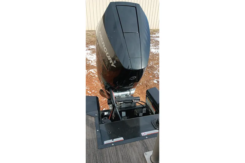 Slide: The Image of 2024 Ranger 2500LS boat with Mercury outboard motor, parked on snowy ground. - 34