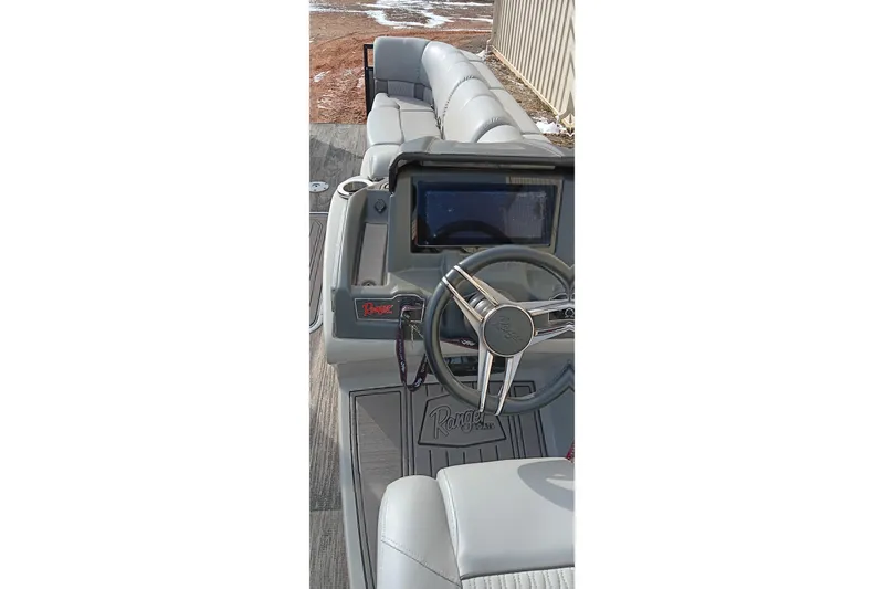 Slide: The Image of 2024 Ranger 2500LS boat interior with steering wheel and seating. - 35