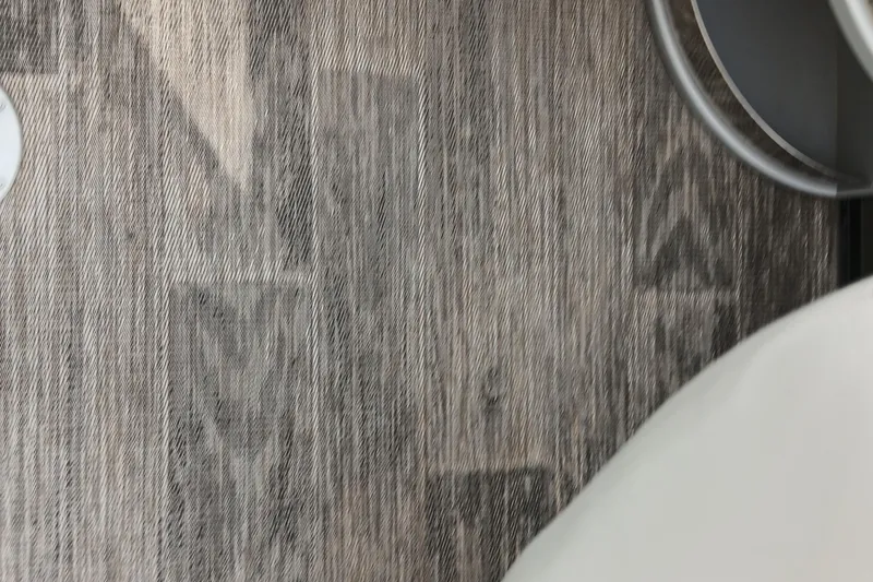 Slide: The Image of 2024 Ranger 2500LS boat interior with textured wood flooring detail. - 36