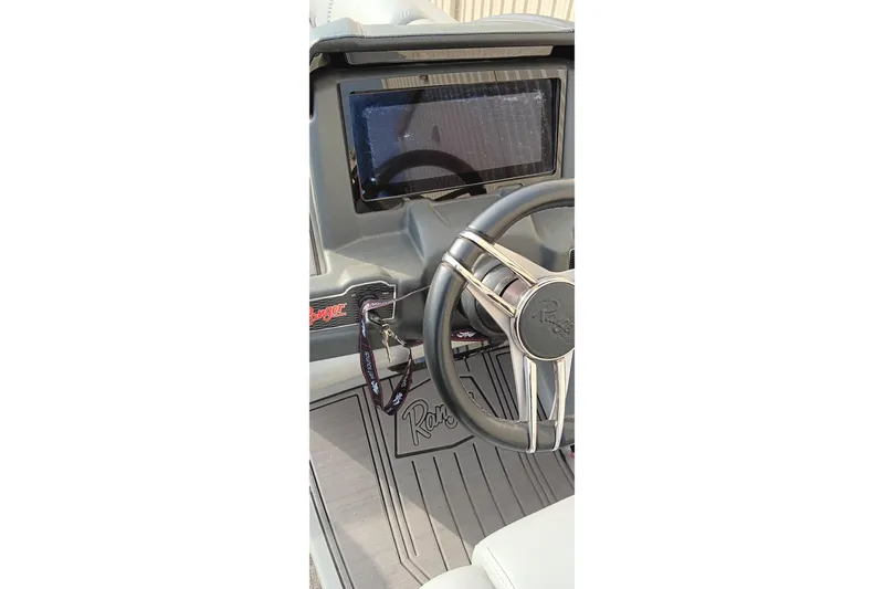 Slide: The Image of Steering wheel and dashboard of 2024 Ranger 2500LS boat, featuring modern controls. - 38