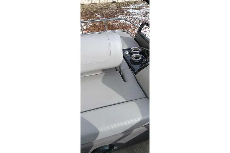 Slide: The Image of 2024 Ranger 2500LS boat interior with gray seating and cup holders. - 41