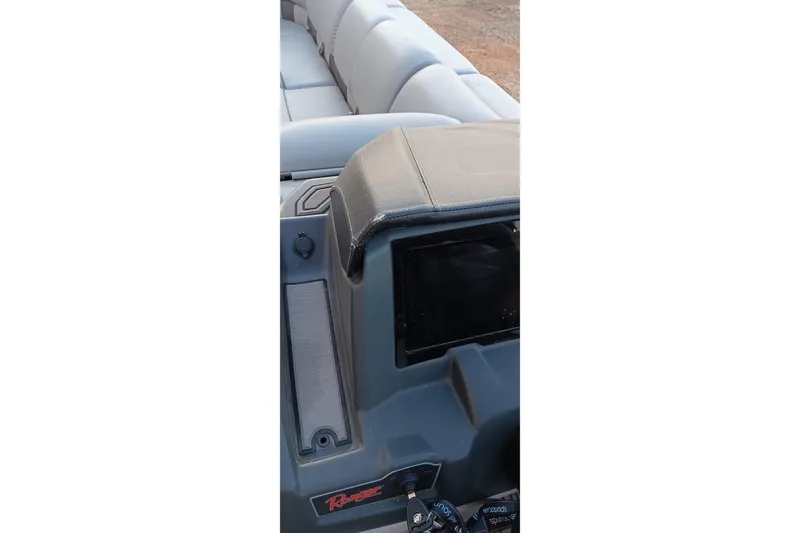 Slide: The Image of 2024 Ranger 2500LS boat dashboard with seating in the background. - 59