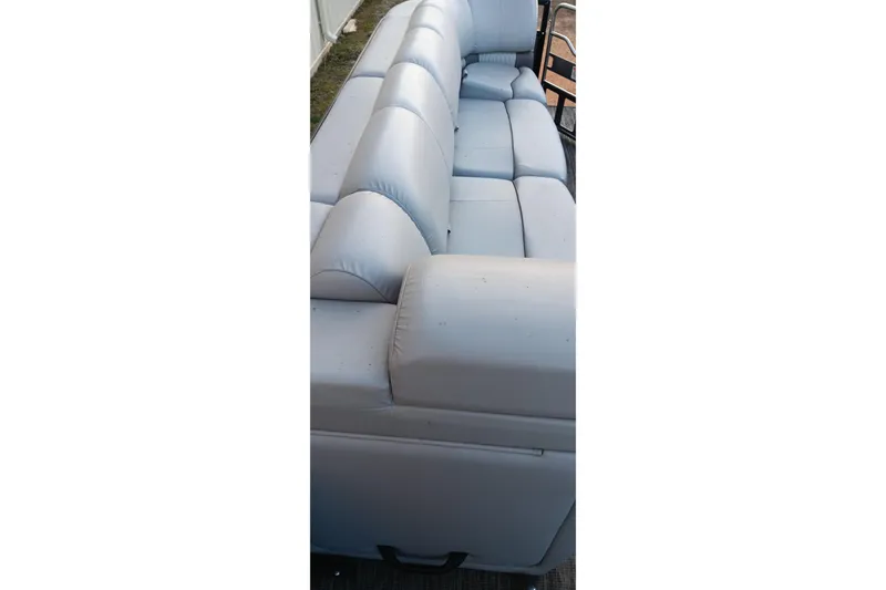 Slide: The Image of 2024 Ranger 2500LS boat seating, featuring plush, light gray upholstery. - 61
