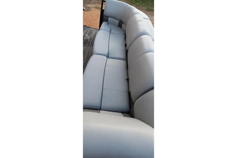 Slide: The Image of 2024 Ranger 2500LS boat interior with spacious, cushioned seating in light gray upholstery. - 62