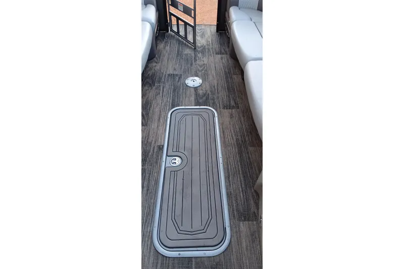 Slide: The Image of 2024 Ranger 2500LS boat interior with sleek flooring and storage compartment. - 64