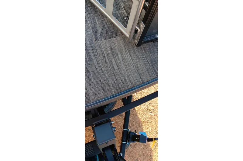 Slide: The Image of 2024 Ranger 2500LS boat deck with textured flooring and metal railing. - 76