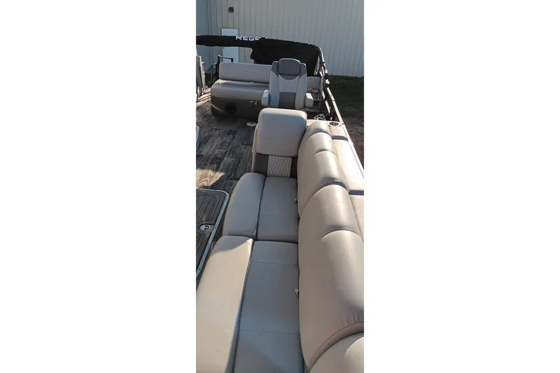 Slide: The Image of 2024 Ranger 2500LS boat interior with beige seating and wood-style flooring. - 78