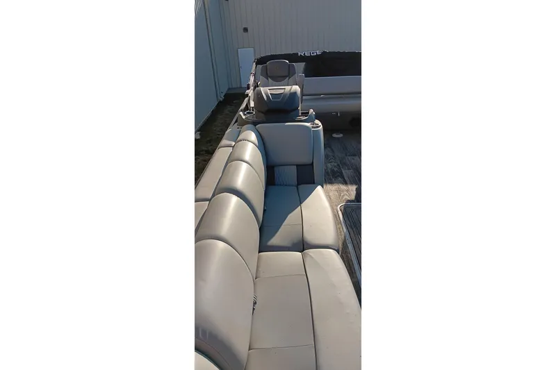 Slide: The Image of 2024 Ranger 2500LS boat interior with gray seating and helm. - 79