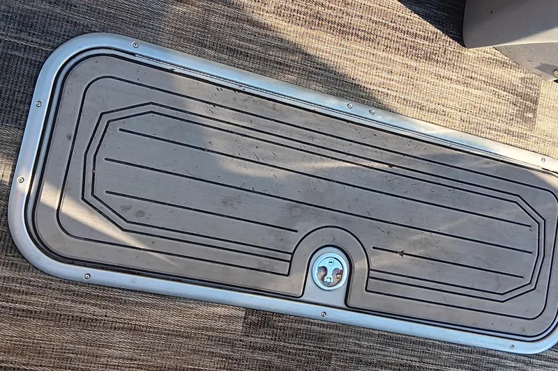 Slide: The Image of 2024 Ranger 2500LS boat hatch on textured flooring, featuring a secure latch. - 80