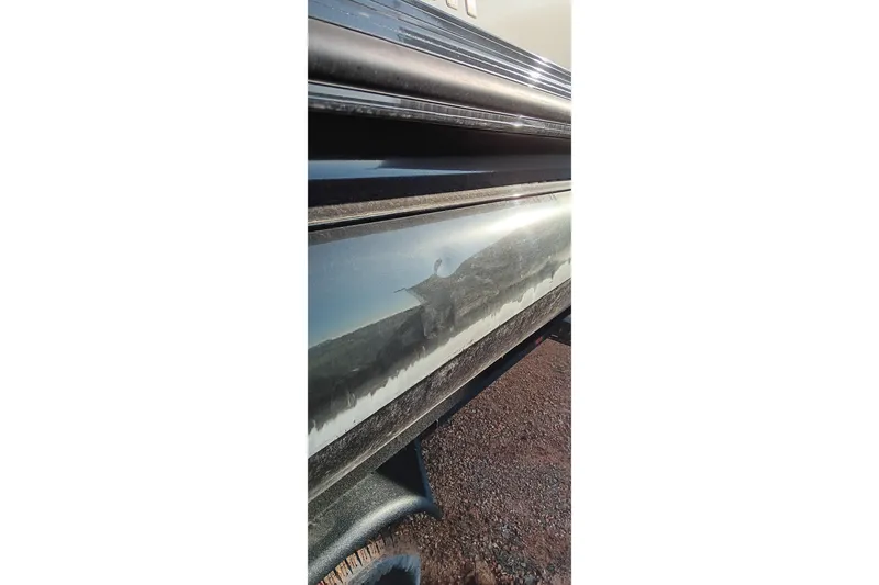 Slide: The Image of 2024 Ranger 2500LS boat hull reflecting surroundings on a sunny day. - 91