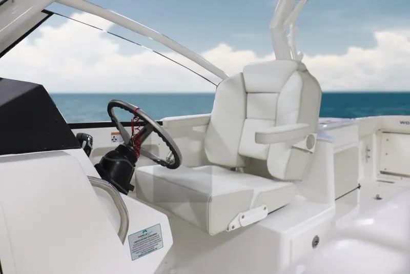 Slide: The Image of Manufacturer Provided Image: 2026 World Cat 280 DC-X boat interior with white seating and ocean view. - 8