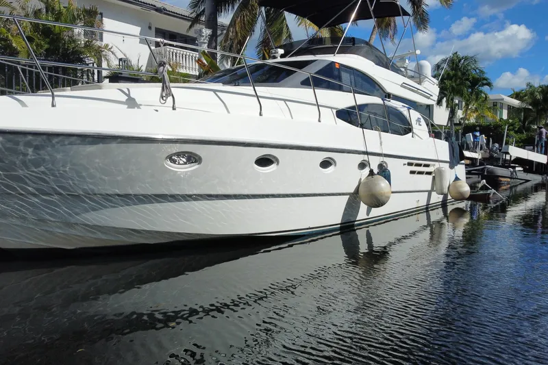 Slide: The Image of 1998 Azimut 52 yacht docked in sunny marina with palm trees. - 18