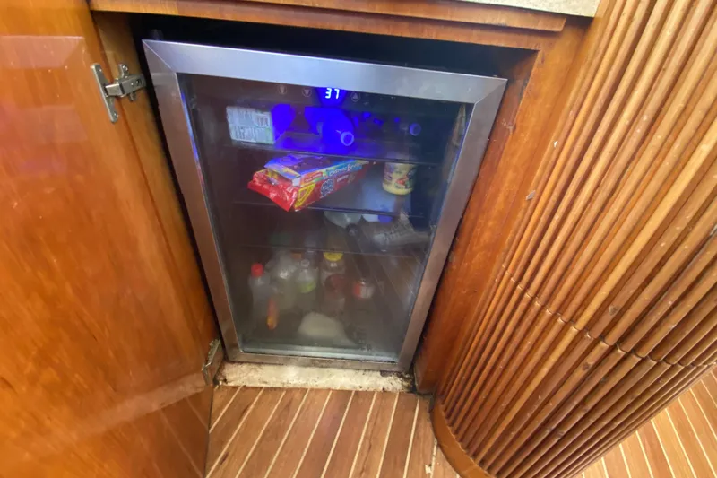 Slide: The Image of Mini fridge inside 1998 Azimut 52 yacht, stocked with drinks and snacks. - 32