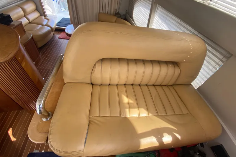 Slide: The Image of Luxurious beige leather seating inside a 1998 Azimut 52 yacht, featuring elegant wood accents. - 33