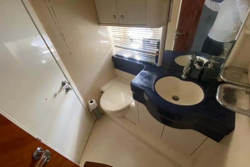 Slide: The Image of Bathroom interior of a 1998 Azimut 52 yacht, featuring a sink and toilet. - 40