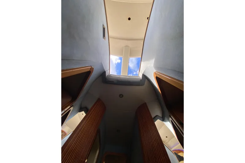 Slide: The Image of Interior view of 1998 Azimut 52 yacht, showcasing skylight and wooden accents. - 45