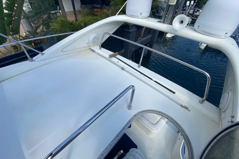 Slide: The Image of Flybridge of 1998 Azimut 52 yacht with stainless steel railings and marina view. - 52