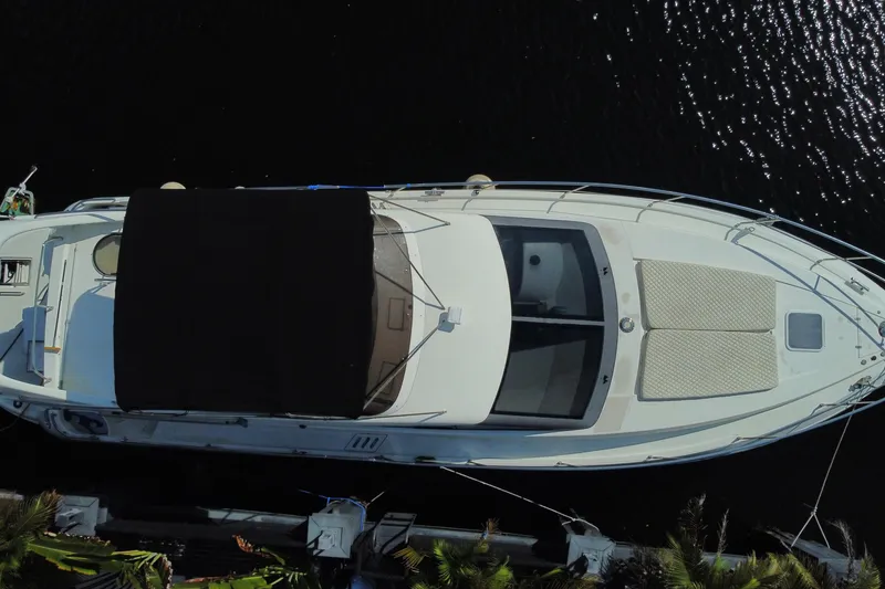 Slide: The Image of Overhead view of a 1998 Azimut 52 yacht docked by the water. - 65