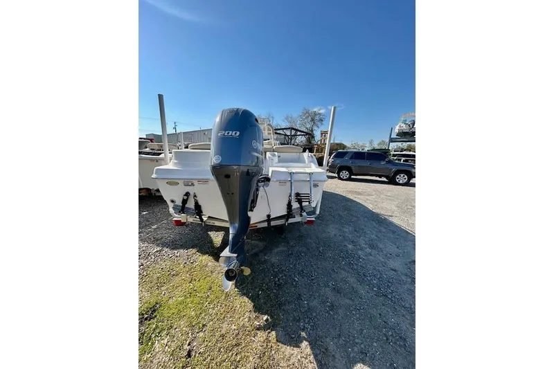 Slide: The Image of 2022 NauticStar 2102 Legacy boat with 200 HP engine, parked outdoors. - 10