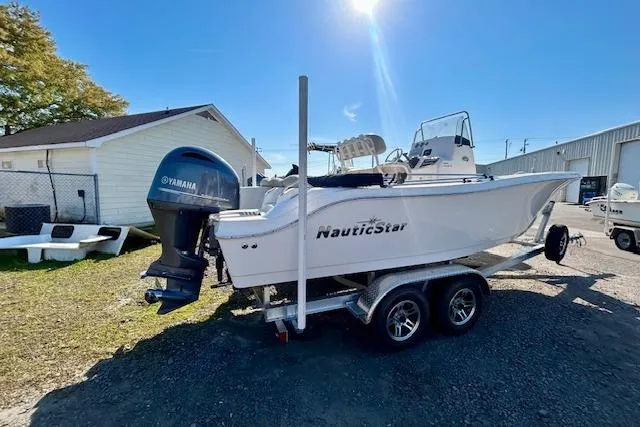 Slide: The Image of 2022 NauticStar 2102 Legacy boat on trailer with Yamaha outboard motor. - 11
