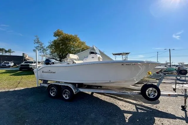 Slide: The Image of 2022 NauticStar 2102 Legacy boat on trailer under clear blue sky. - 12