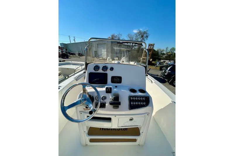 Slide: The Image of 2022 NauticStar 2102 Legacy boat dashboard with steering wheel and controls. - 4