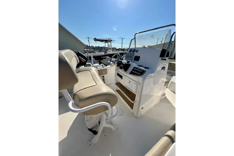 Slide: The Image of 2022 NauticStar 2102 Legacy boat interior with helm and seating. - 5
