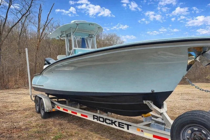 The Image of 2019 Stoner 23 CC boat on trailer under blue sky. - 0