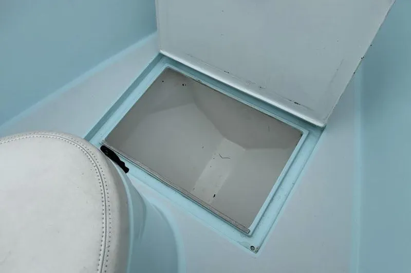 Slide: The Image of Interior of a 2019 Stoner 23 CC boat showing a storage compartment. - 12