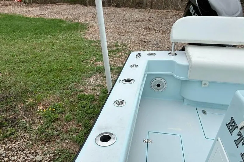 Slide: The Image of 2019 Stoner 23 CC boat interior with seating and rod holders. - 13