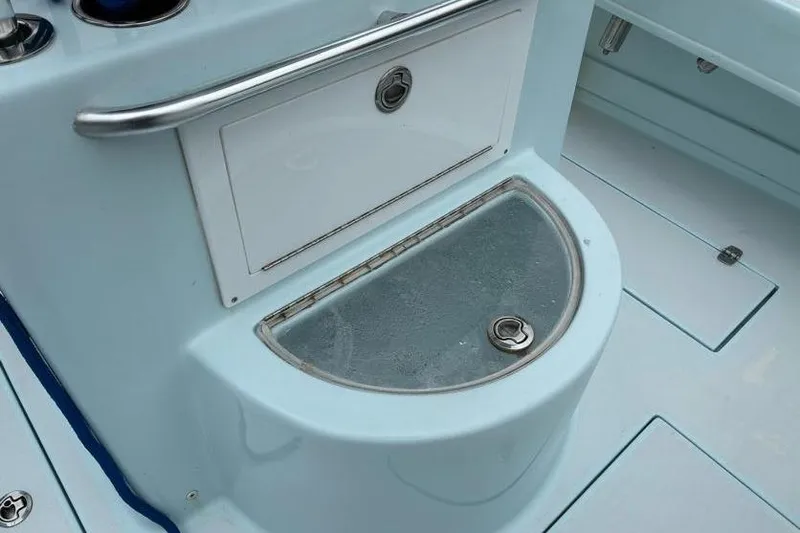 Slide: The Image of 2019 Stoner 23 CC boat interior with storage compartments and stainless steel railing. - 14