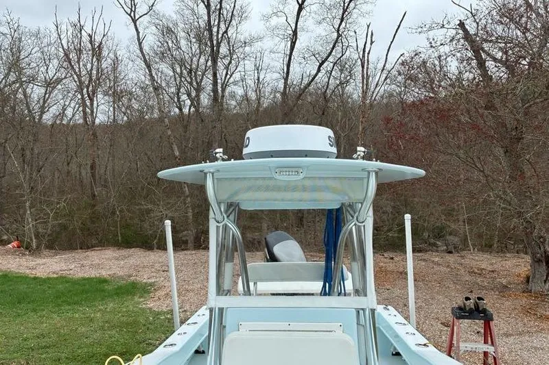 Slide: The Image of 2019 Stoner 23 CC boat in wooded area, showcasing its sleek design and radar equipment. - 9