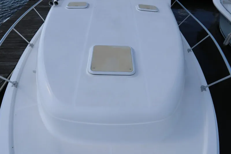 Slide: The Image of 2002 Mainship Pilot 34 boat deck with hatches and railing. - 12