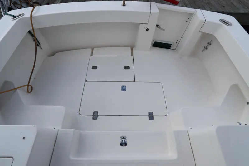 Slide: The Image of 2001 Mainship Pilot 34 boat deck, featuring storage compartments and clean white surface. - 18