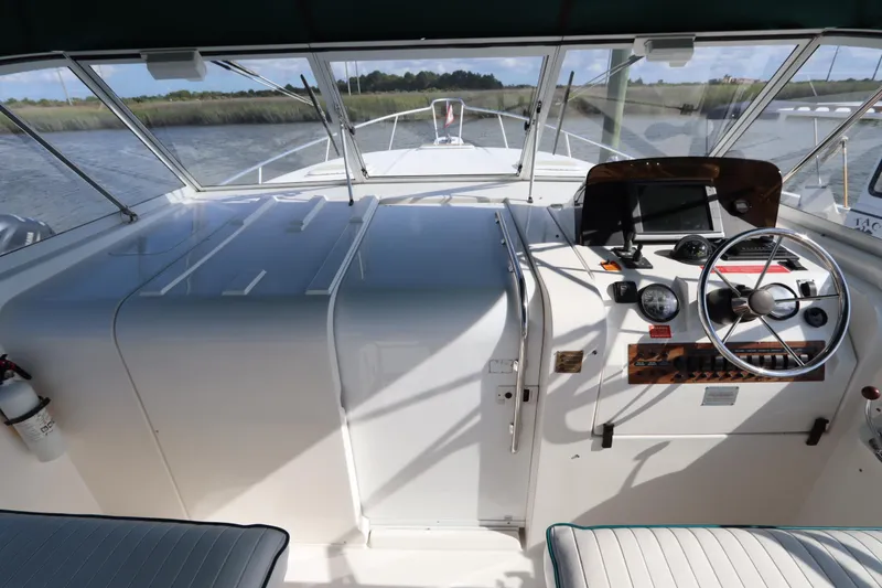 Slide: The Image of 2002 Mainship Pilot 34 helm with steering wheel, gauges, and navigation equipment. - 21