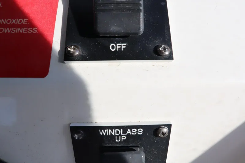 Slide: The Image of Control panel of a 2002 Mainship Pilot 34 with "OFF" and "WINDLASS UP" switches. - 24