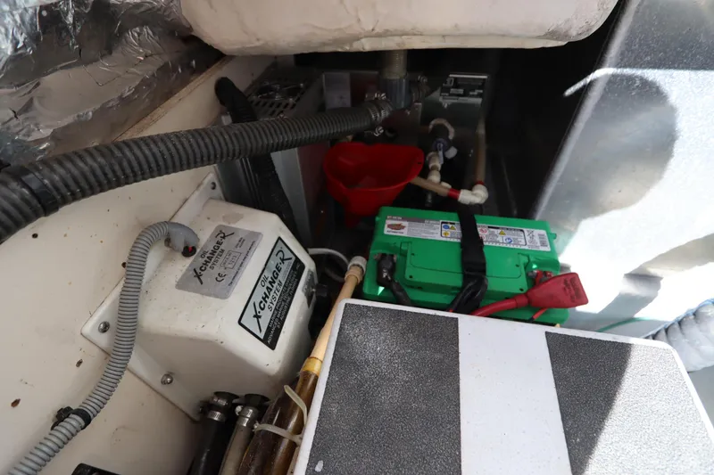 Slide: The Image of Engine compartment of a 2002 Mainship Pilot 34 with battery and wiring. - 34