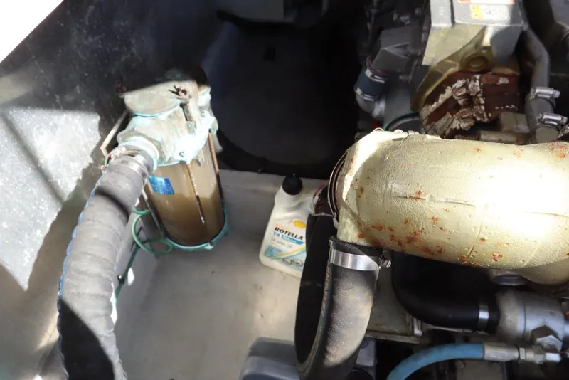 Slide: The Image of Engine compartment of a 2002 Mainship Pilot 34 with visible components and oil container. - 38