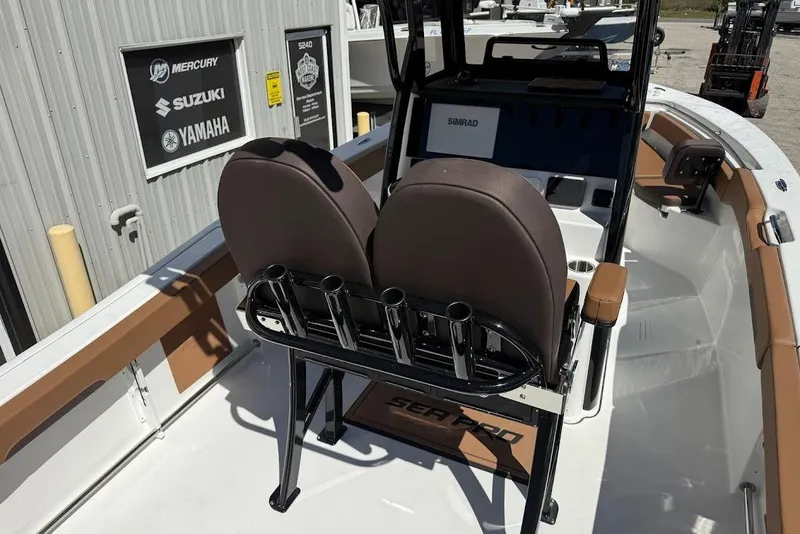Slide: The Image of 2026 Sea Pro 242 Center Console boat interior with dual seats and rod holders. - 10